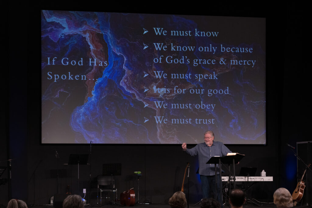 Pastor Gary Piercy preaching with slide deck